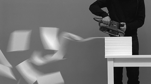 sander shoots stack of pages